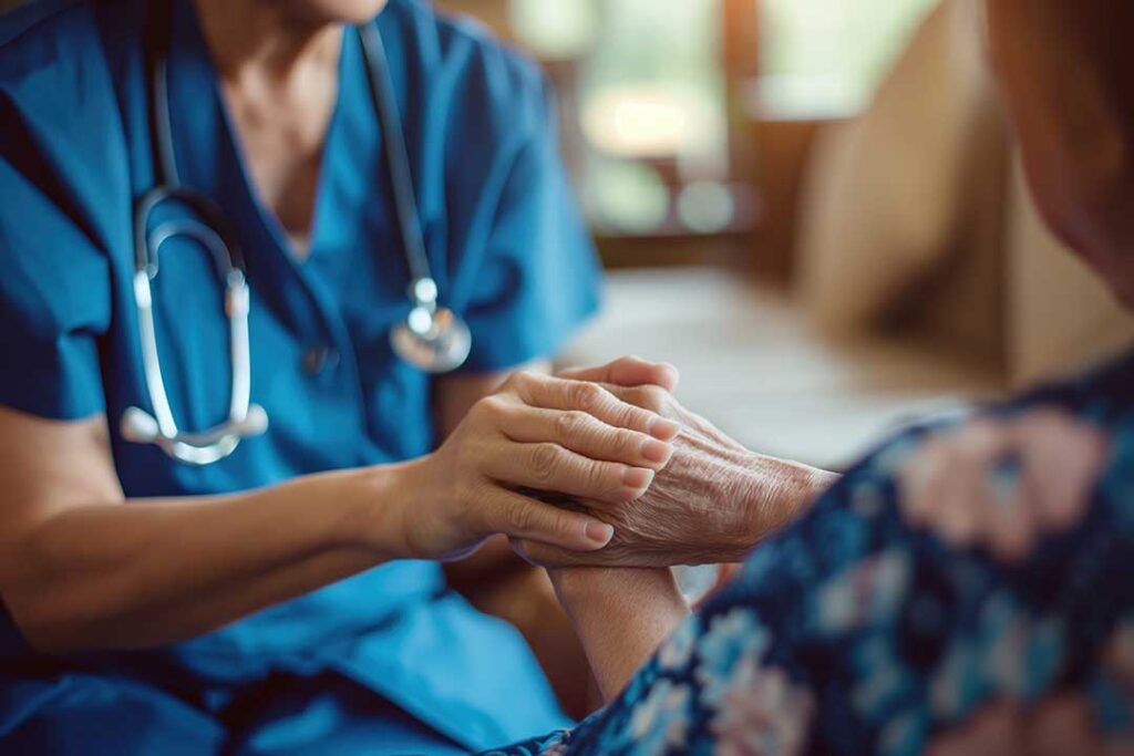Older adult and caregiver review labeled medicine bottles beside a written medication schedule at a kitchen table.